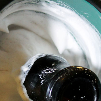 lathering shaving soap in a mug