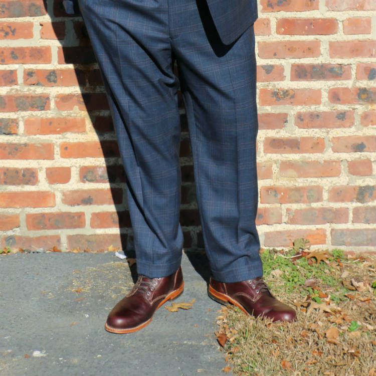 man in suit wearing wolverine boots