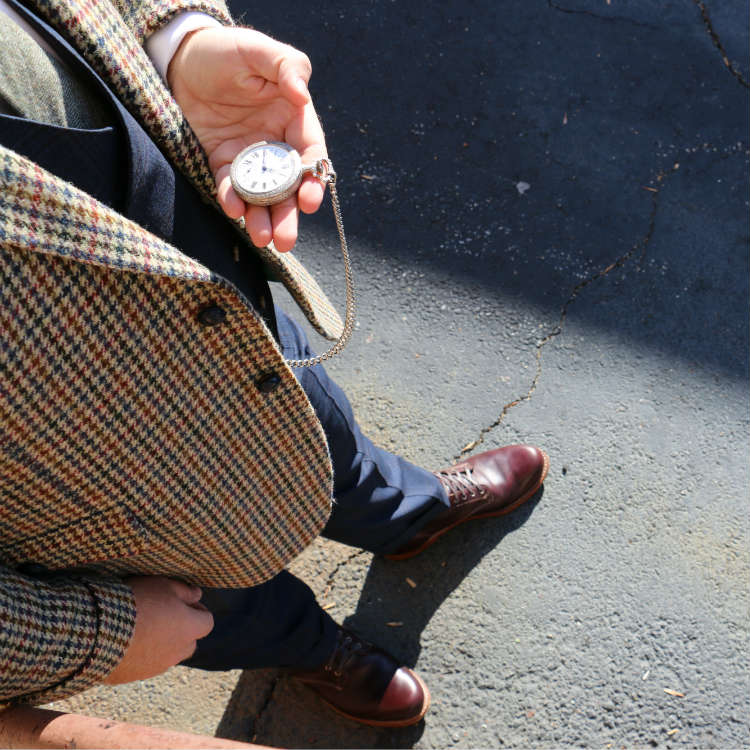 man looking at pocketwatch