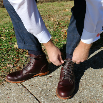 man tying wolverine cordovan boots