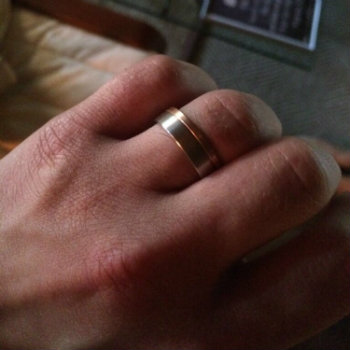 man's wedding band on a hand