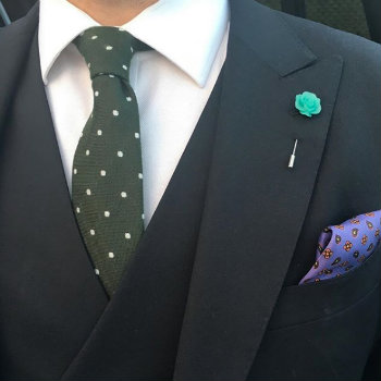 green dot tie with navy suit