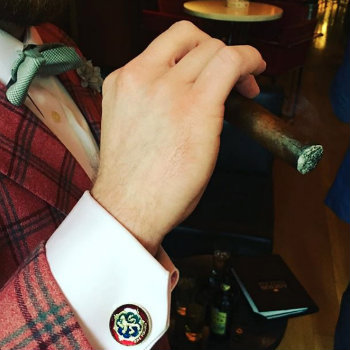 man in cocktail attire smoking cigar