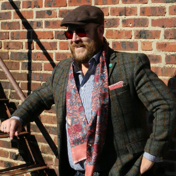 man in red paisley scarf and sport coat