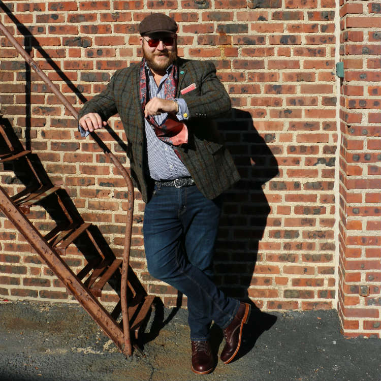 man in scarf checking watch