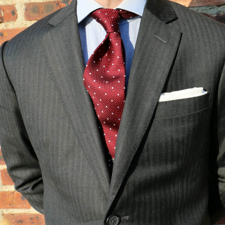 red dotted tie with white pocket square
