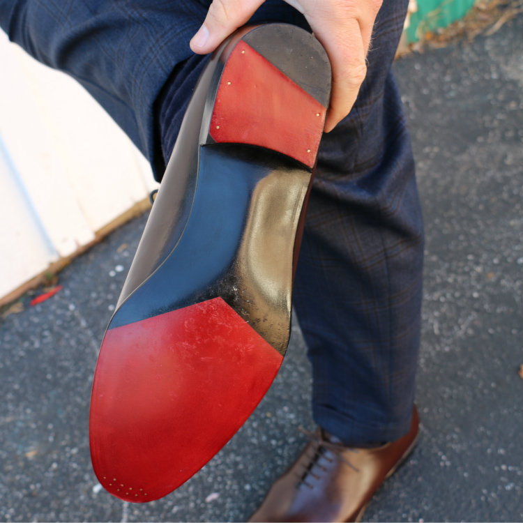 red sole on wholecut shoe