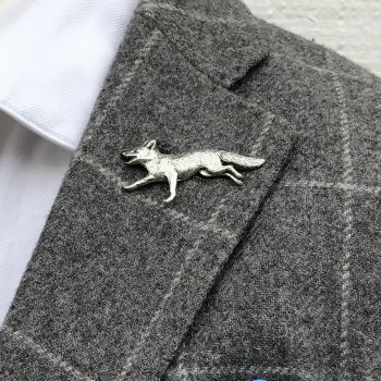 silver animal lapel pin on grey coat