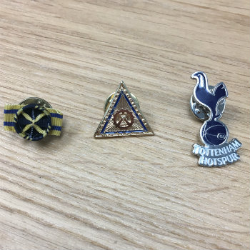 three lapel pins in a row