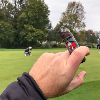 Smoking Cigar At Golf Course