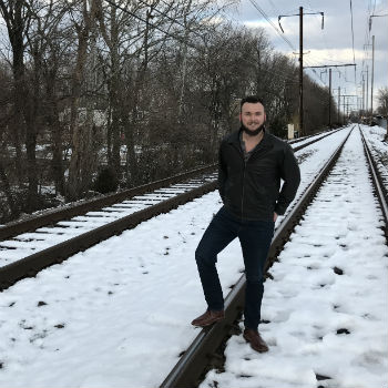 Trevor Guilday On Railroad With Leather Chukka Boots