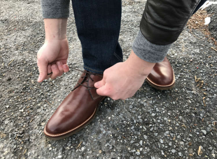 Tying Laces Of Chukka Boots On Street