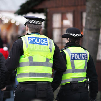 British Police Officers Patrol Winter Market