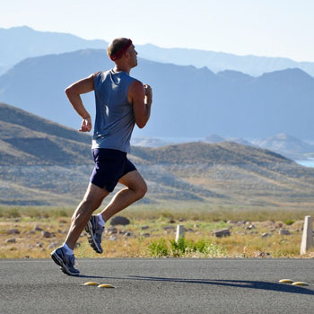 Man Jogging By Lake & Mountains