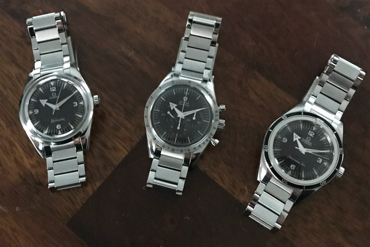 Omega 1957 Trilogy Watches Displayed On Table