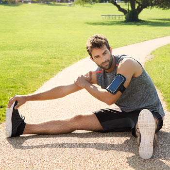 Sportsman Stretching In Park