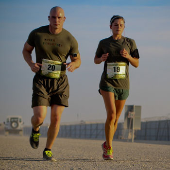 military couple running a marathon