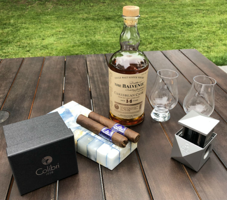 Colibri Quasar Cigar Cutter with whisky and cut cigars