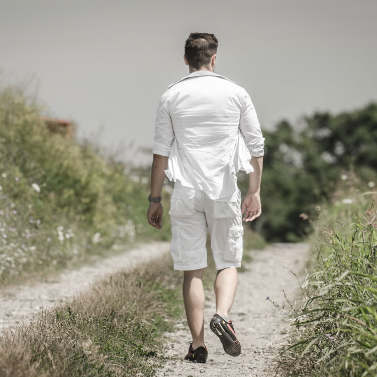 Man Walking Away On Countryside Road