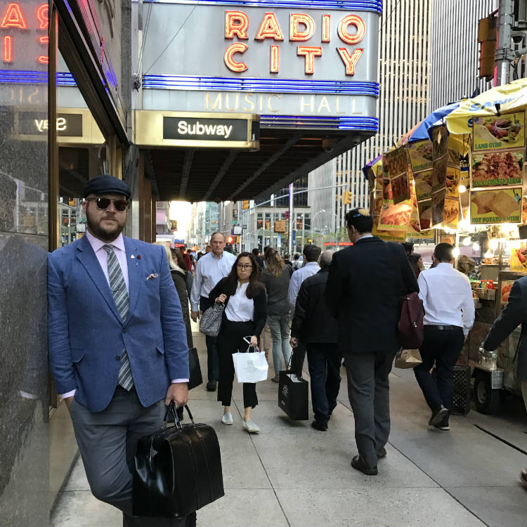 Paul Anthony holding leather weekender in NYC