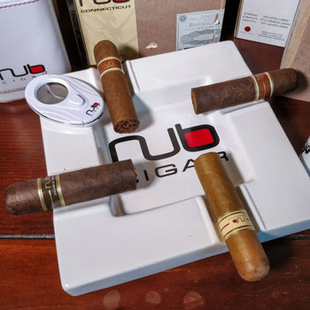 Assortment Of Nub Cigars On Branded Ashtray