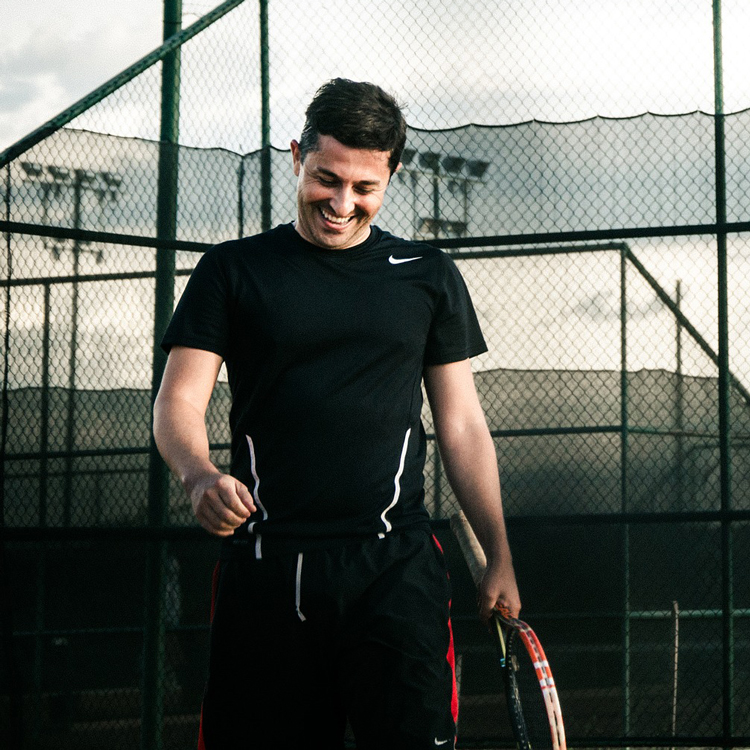 Male Tennis Player Walking Away From Court