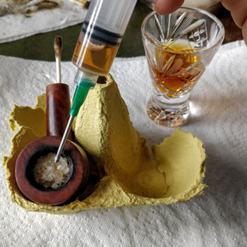Filling Pipe Bow With Alcohol