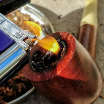 Lighting A Tobacco Pipe Close Up