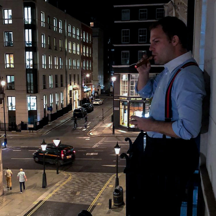 Relaxing On Balcony With Cigar At Night