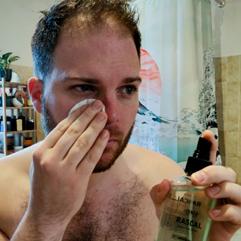 Man Applying Rascal Face Toner With Cotton Pad