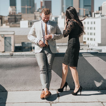 Man & Woman In Cocktail Attire On Rooftop