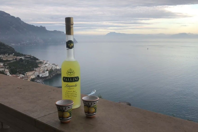 Pallini Limoncello Bottle & Ceramic Glasses WIth Coastal View