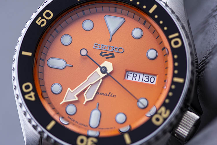 SBSA009 Orange Dial Close up Gold Hands