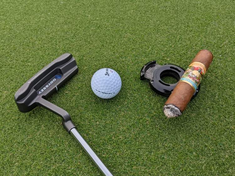 Xikar XO Cigar Cutter With Putter and Golf Ball on Green