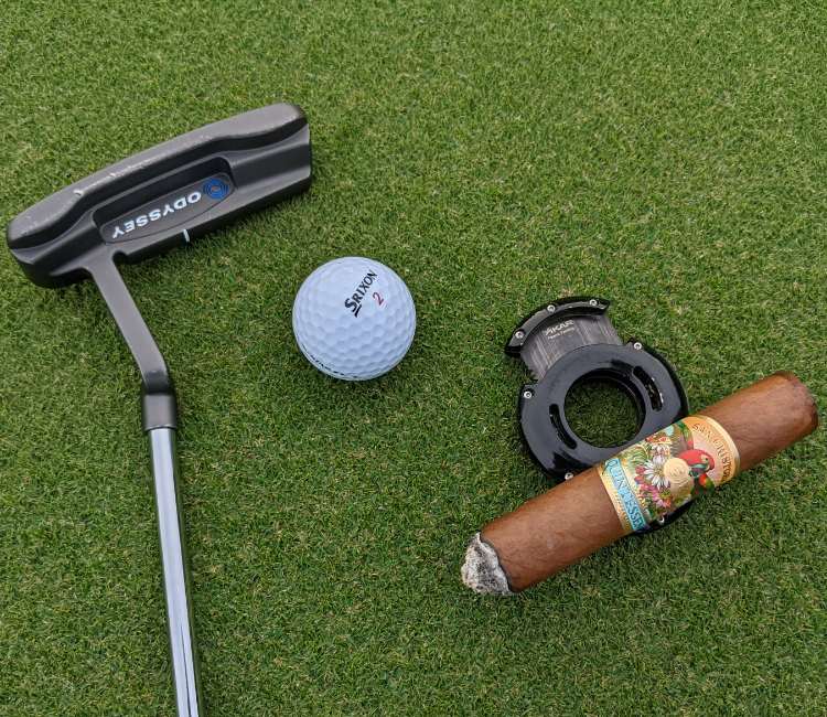 Xikar XO Cutter being used a cigar rest on golf course