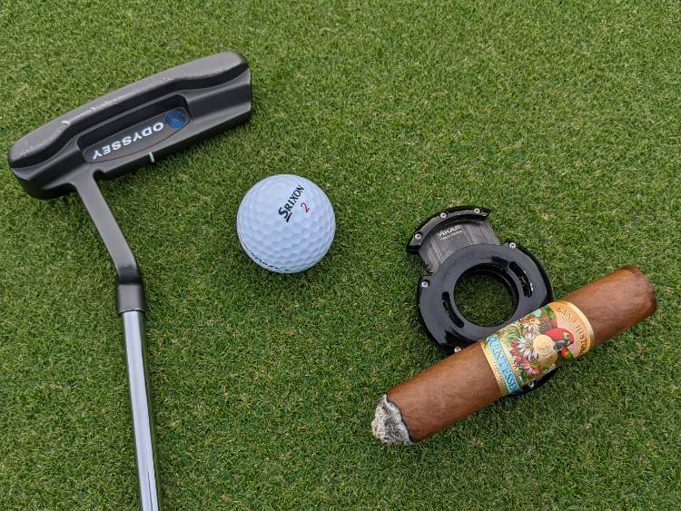Xikar XO Cutter being used a cigar rest on golf course