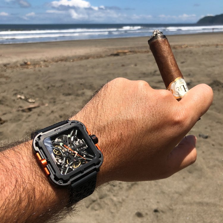 Wristshot of CIGA Design X Series with Cigar At Beach