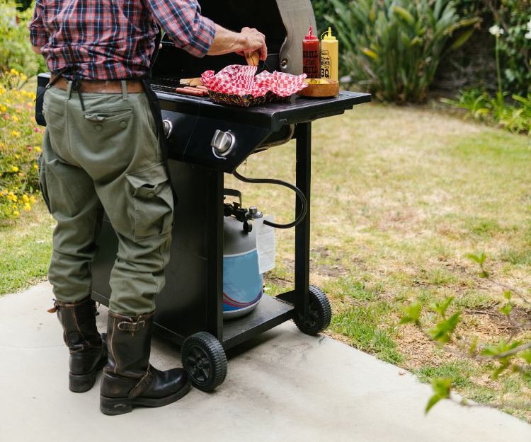 Man Wearing Motorcycle Boots While BBQing