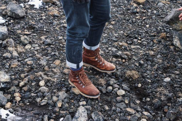 Brown Leather Hiking Boots And Blue Jeans