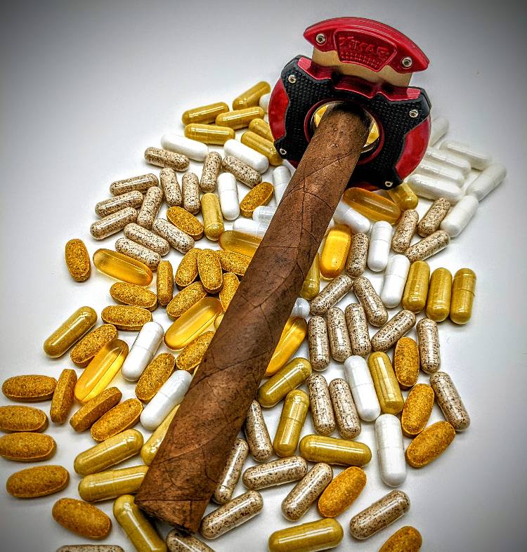 Cigar cutter and tobacco with vitamin tablets