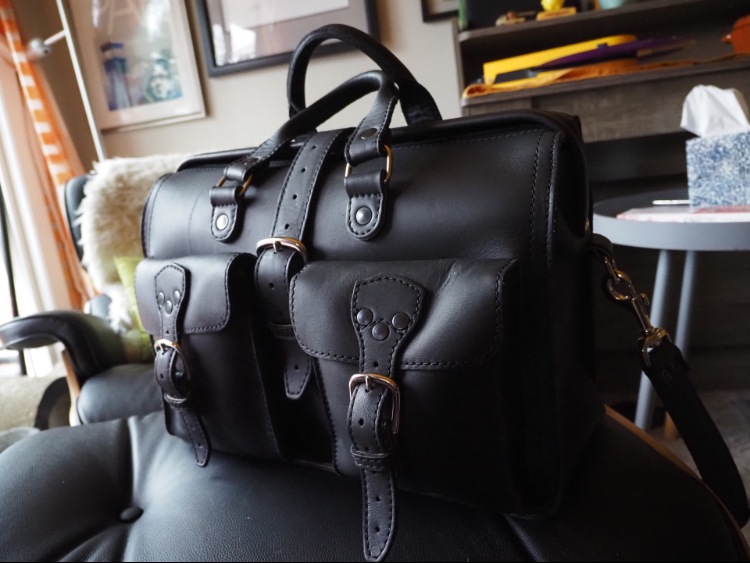 Metal Buckles & Black Leather Details Of Flight Bag